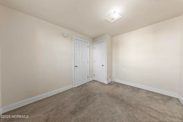a living room with furniture a table and kitchen view