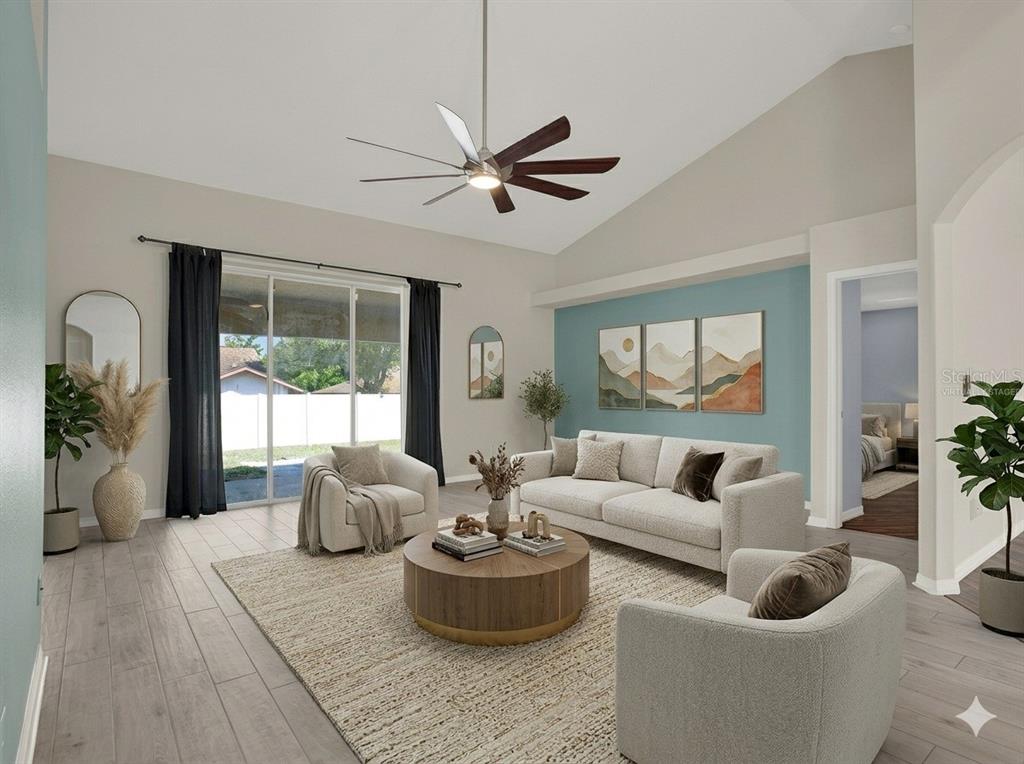 4400 Dior Road Spring Hill, FL 34609 - Photo 10 of 37 a living room with furniture and a large window
