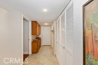 a view of a hallway with closet and a bathroom