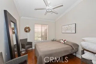 a bed room with a bed mirror and a window