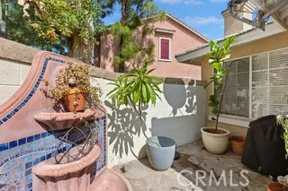 a view of a balcony with table and chairs potted plants