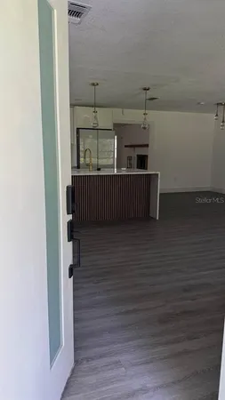 a view of a hallway with wooden floor