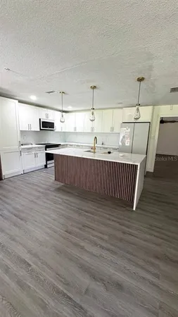 a view of a room with wooden floor