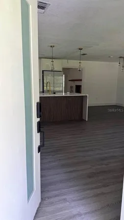 a view of an empty room and wooden floor