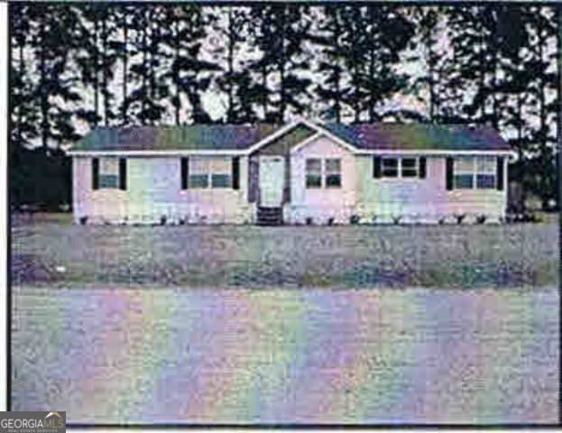 6424 Aruba Road Claxton, GA 30417 - Photo 1 of 1 a front view of a house with a yard