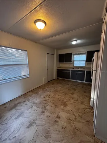 a room with furniture and stainless steel appliances