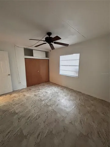 a view of a livingroom with a ceiling fan and window