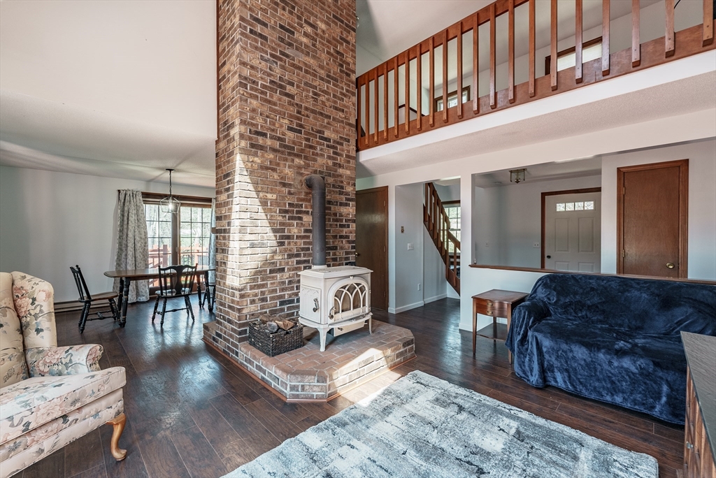 116 Scantic Road Hampden, MA 01036 - Photo 4 of 29 a living room with furniture a fireplace and wooden floor