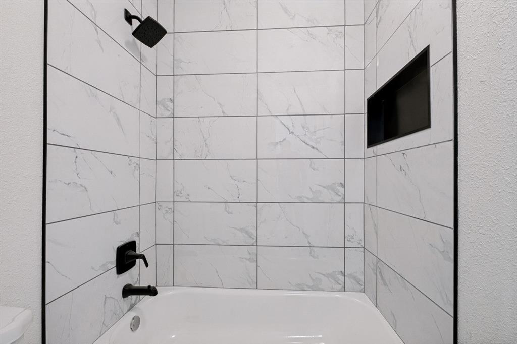 2240 Tarpley Road, Unit 92 Carrollton, TX 75006 - Photo 19 of 22 a bathroom with a bathtub and shower