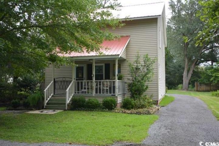 View of front of property featuring a front lawn a
