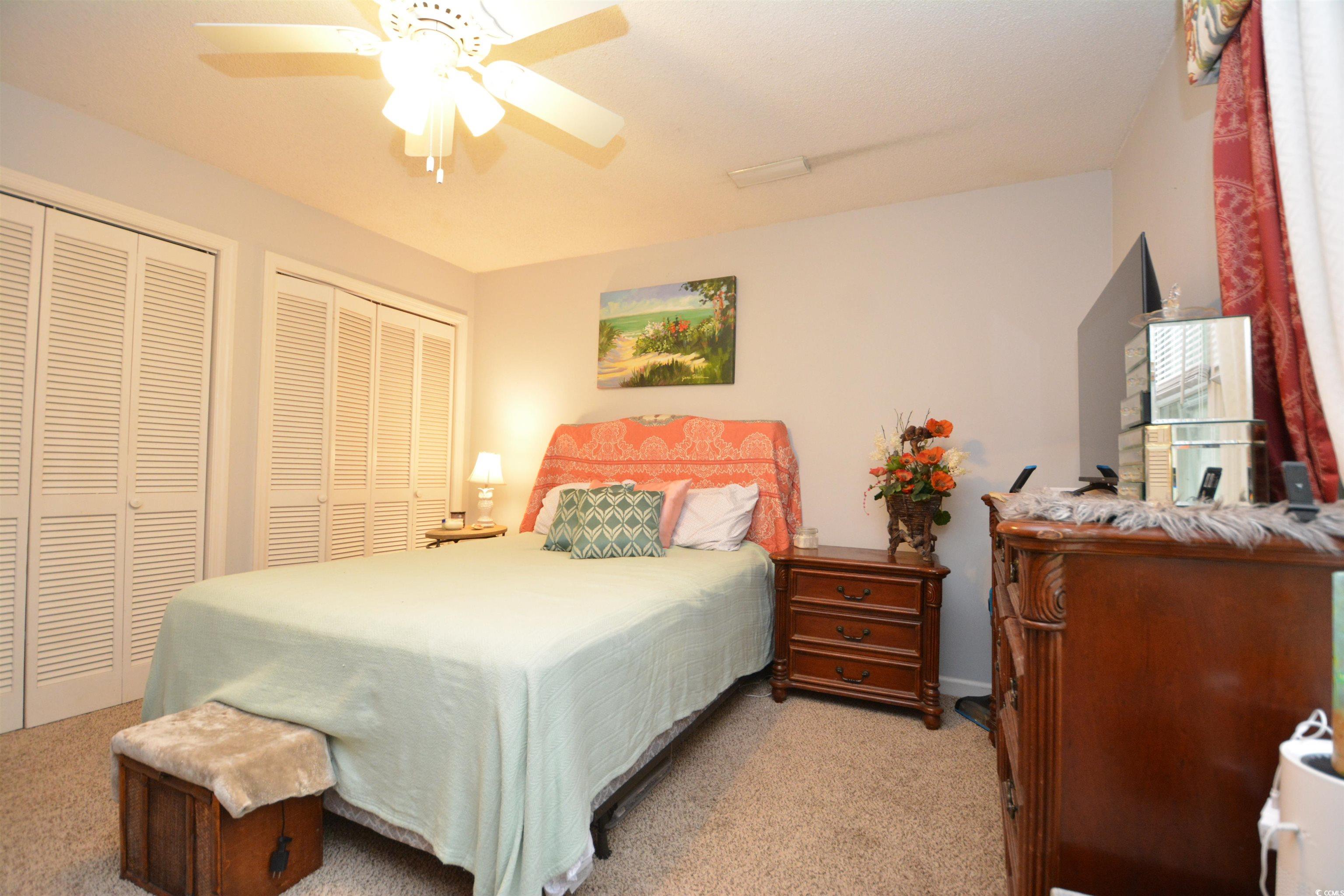 787 Causey Road Murrells Inlet, SC 29576 - Photo 12 of 35 Carpeted bedroom featuring ceiling fan and two clo