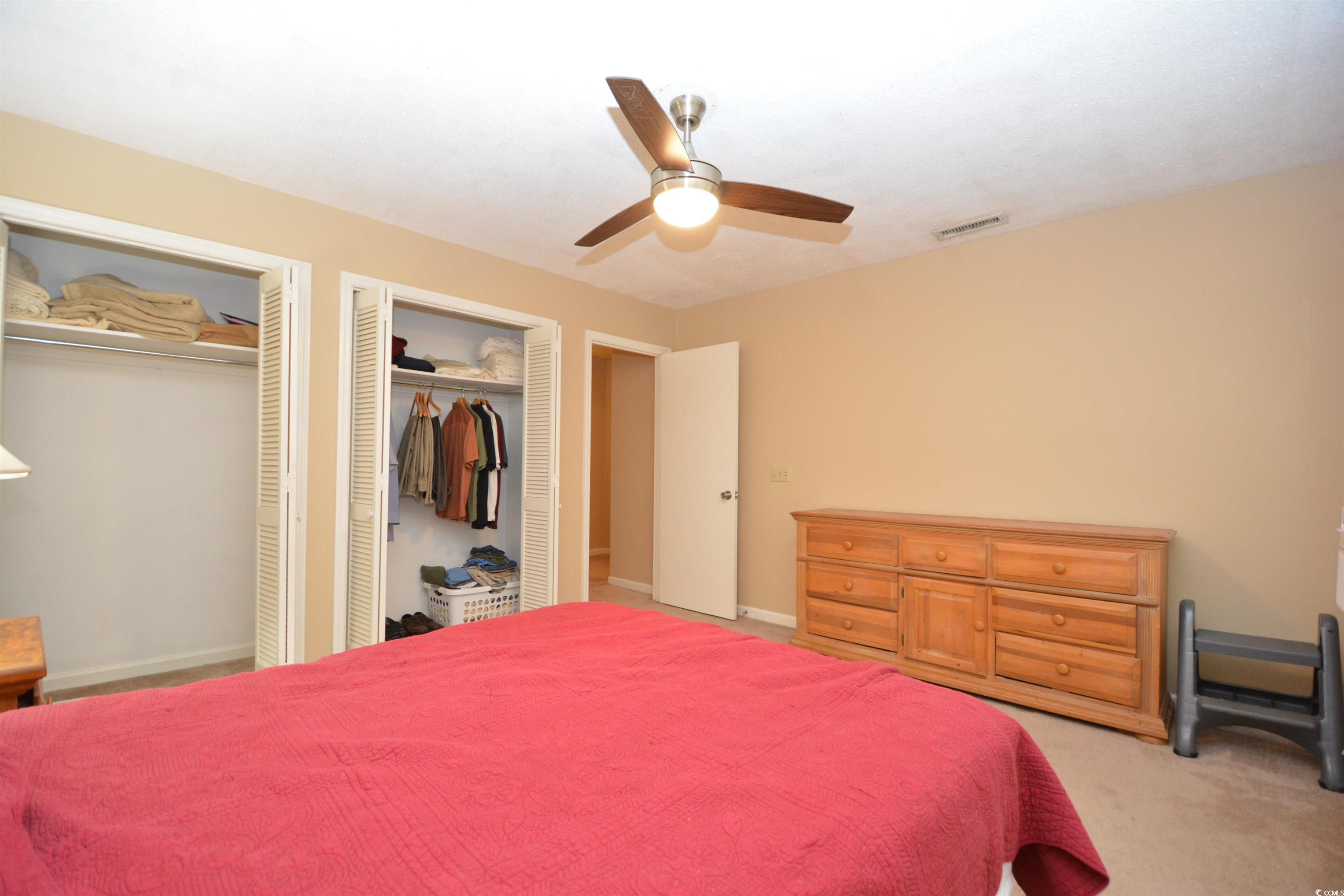 787 Causey Road Murrells Inlet, SC 29576 - Photo 29 of 35 Carpeted bedroom featuring ceiling fan and two clo