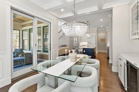 a view of a dining room with furniture and chandelier