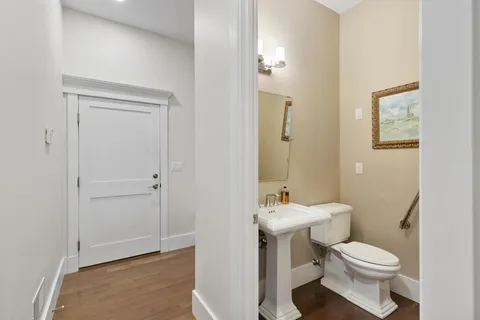 a bathroom with a toilet a sink and mirror