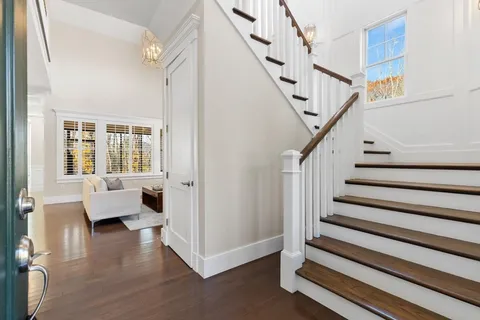 a view of entryway with wooden floor and windows