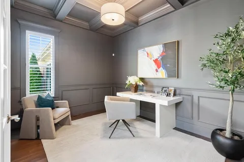 a work room with furniture and a potted plant