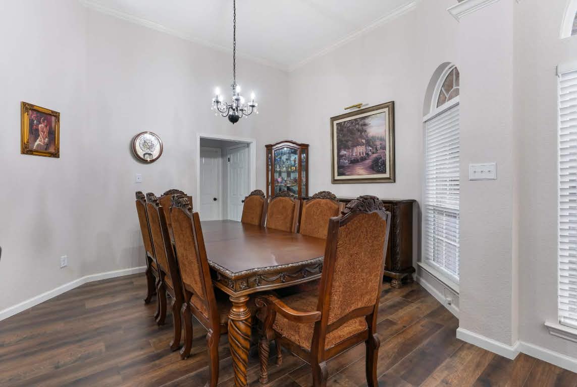 17028 Tortoise Street Round Rock, TX 78664 - Photo 3 of 30 a view of a dining room with furniture wooden floor and a window