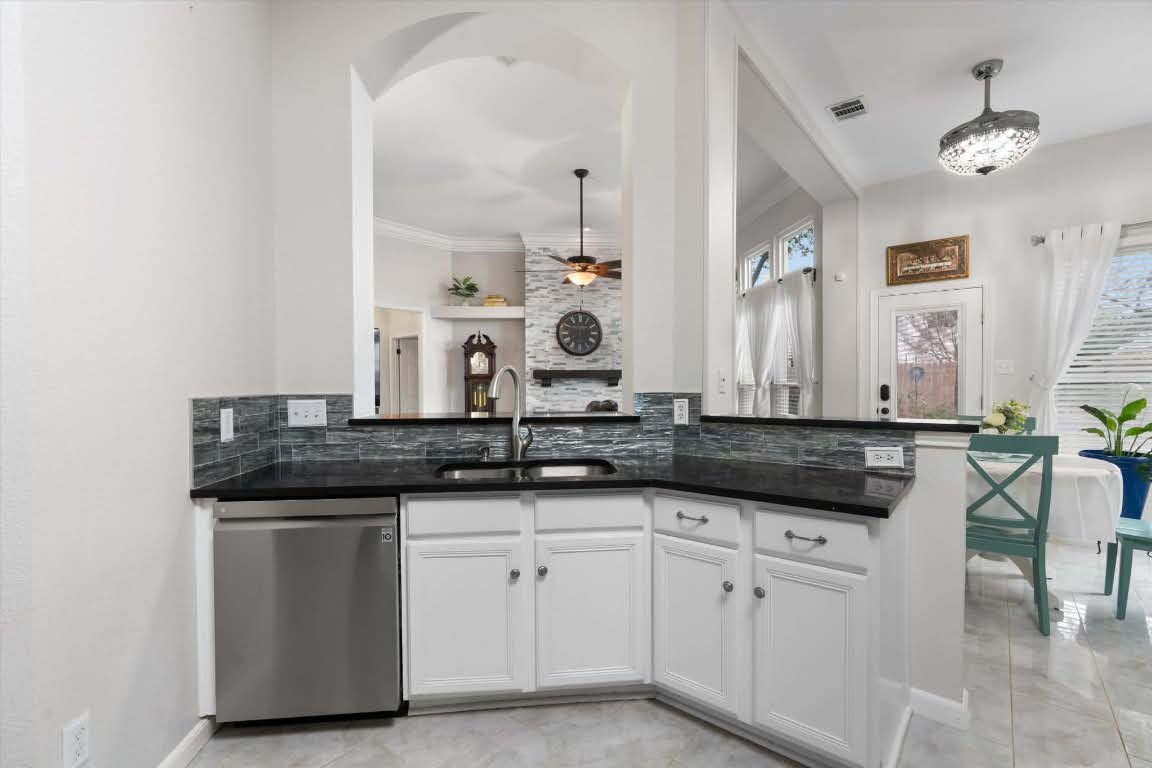 17028 Tortoise Street Round Rock, TX 78664 - Photo 9 of 30 a kitchen with granite countertop a sink and cabinets