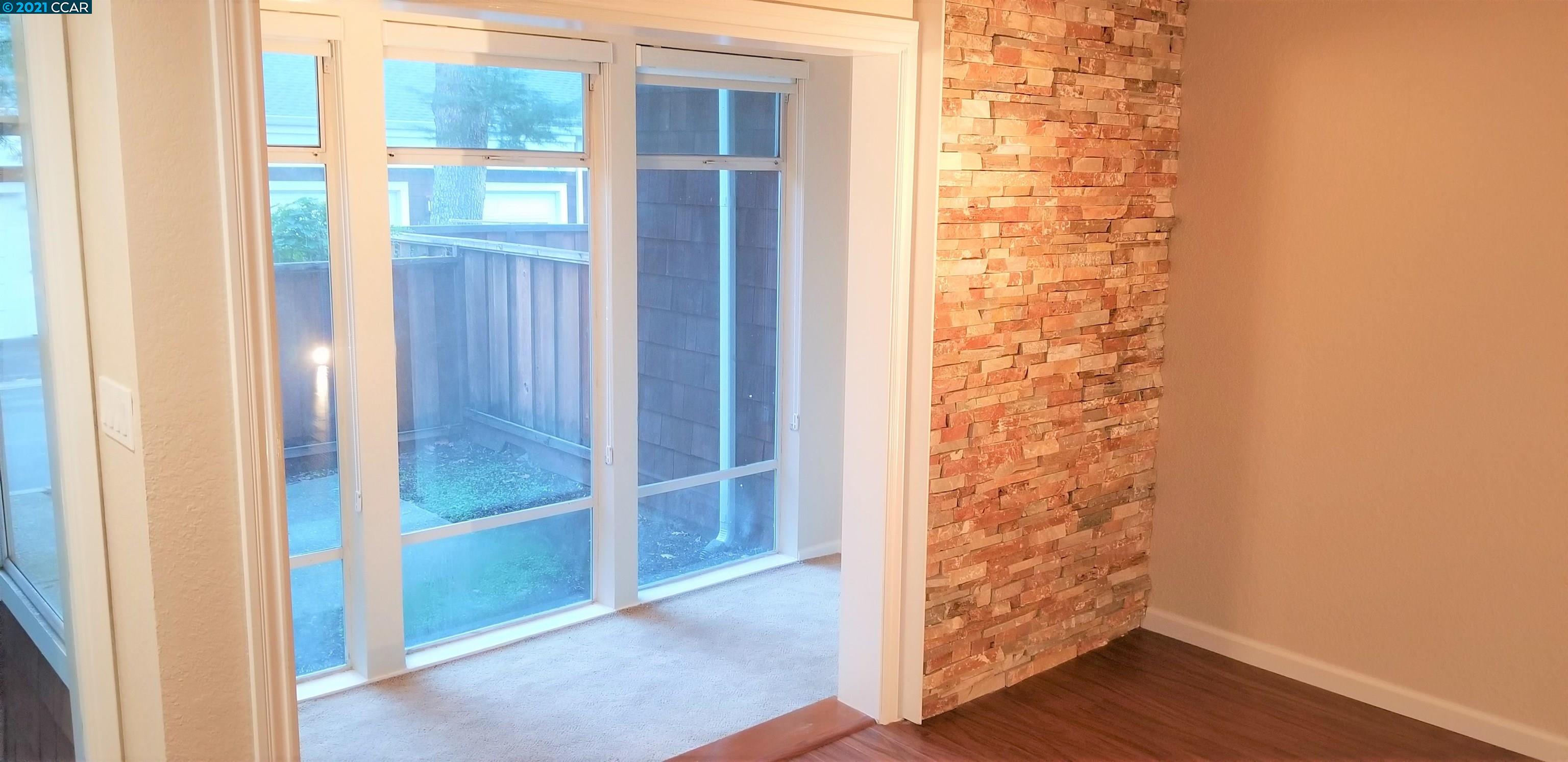 1354 Walden Road Walnut Creek, CA 94597 - Photo 4 of 26 an empty room with wooden floor and entrance door