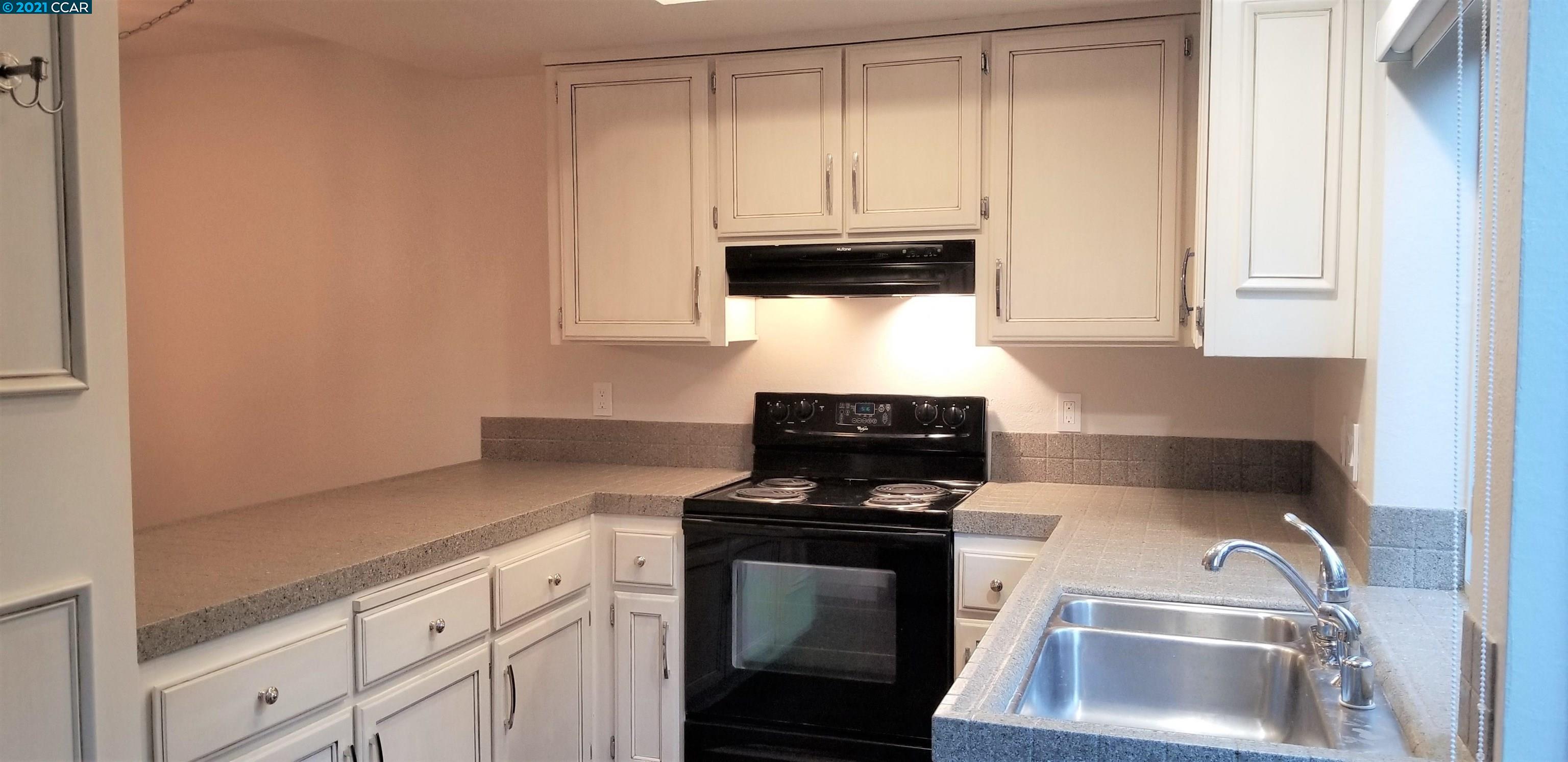 1354 Walden Road Walnut Creek, CA 94597 - Photo 7 of 26 a kitchen with a sink and a stove top oven