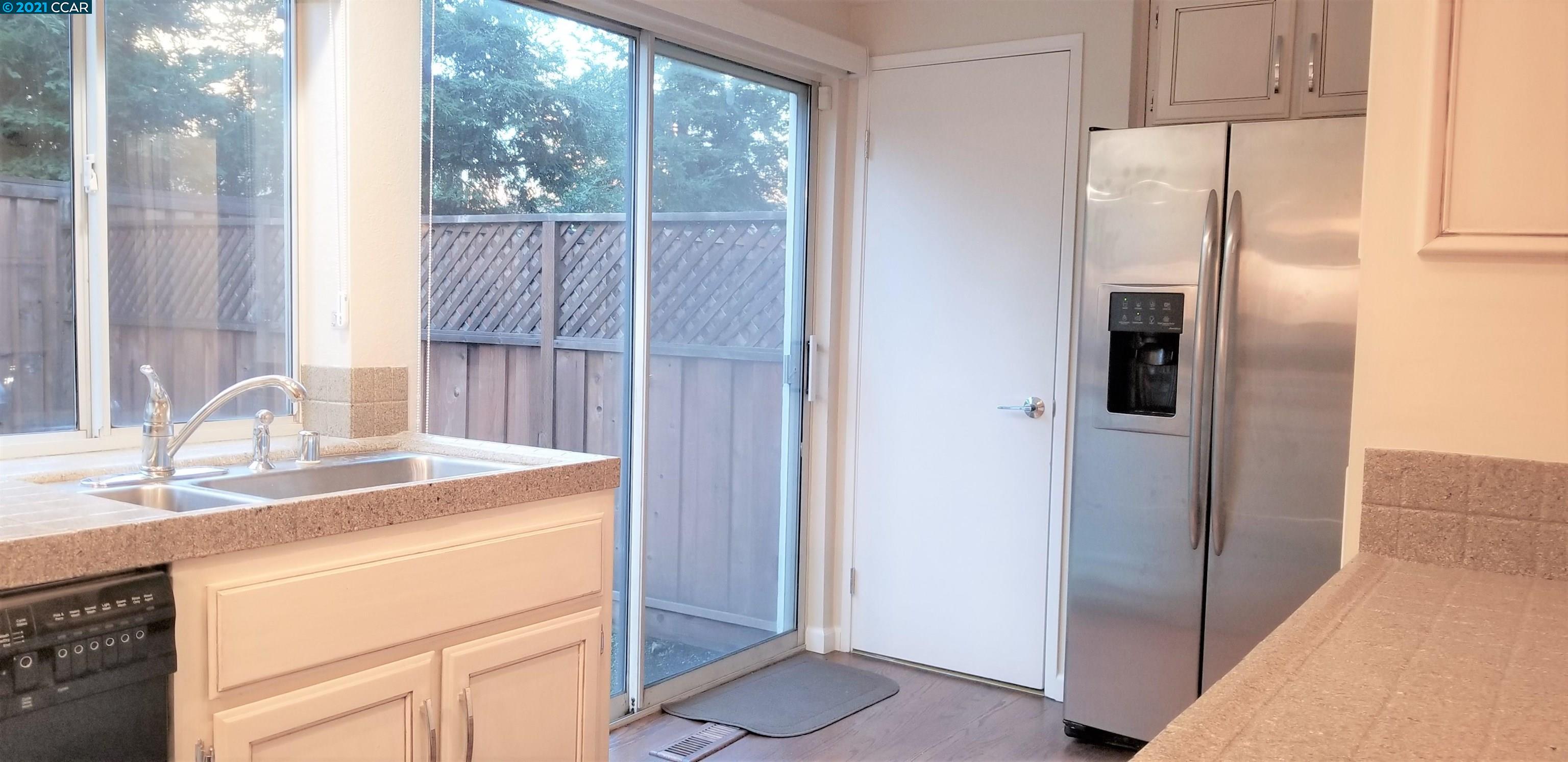 1354 Walden Road Walnut Creek, CA 94597 - Photo 8 of 26 a kitchen with a refrigerator and a sink