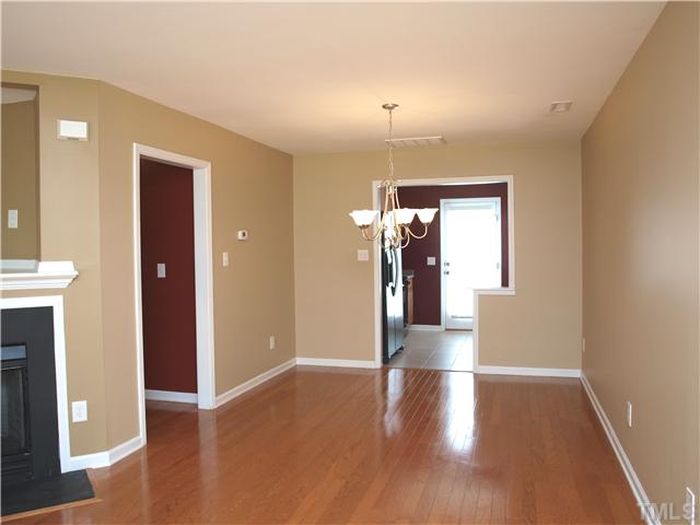 9906 Layla Avenue Raleigh, NC 27617 - Photo 3 of 12 a view of livingroom with hallway and wooden floor