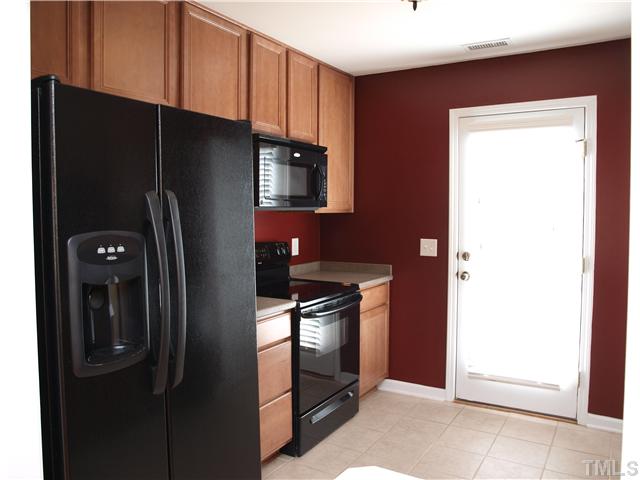9906 Layla Avenue Raleigh, NC 27617 - Photo 6 of 12 a kitchen with metallic refrigerator freezer and a dishwasher
