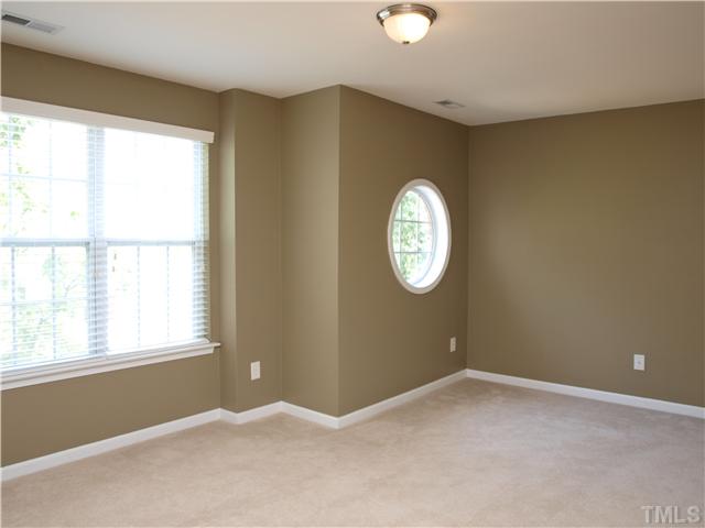 9906 Layla Avenue Raleigh, NC 27617 - Photo 7 of 12 an empty room with windows