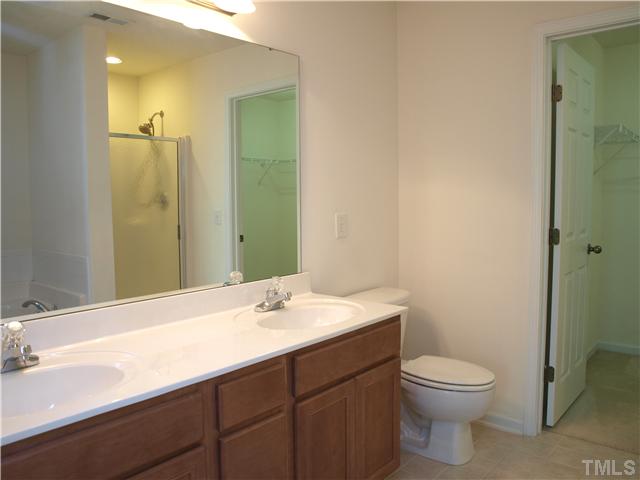 9906 Layla Avenue Raleigh, NC 27617 - Photo 8 of 12 a bathroom with a sink and a mirror