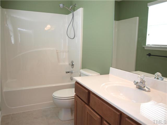 9906 Layla Avenue Raleigh, NC 27617 - Photo 10 of 12 a bathroom with a sink a toilet and shower