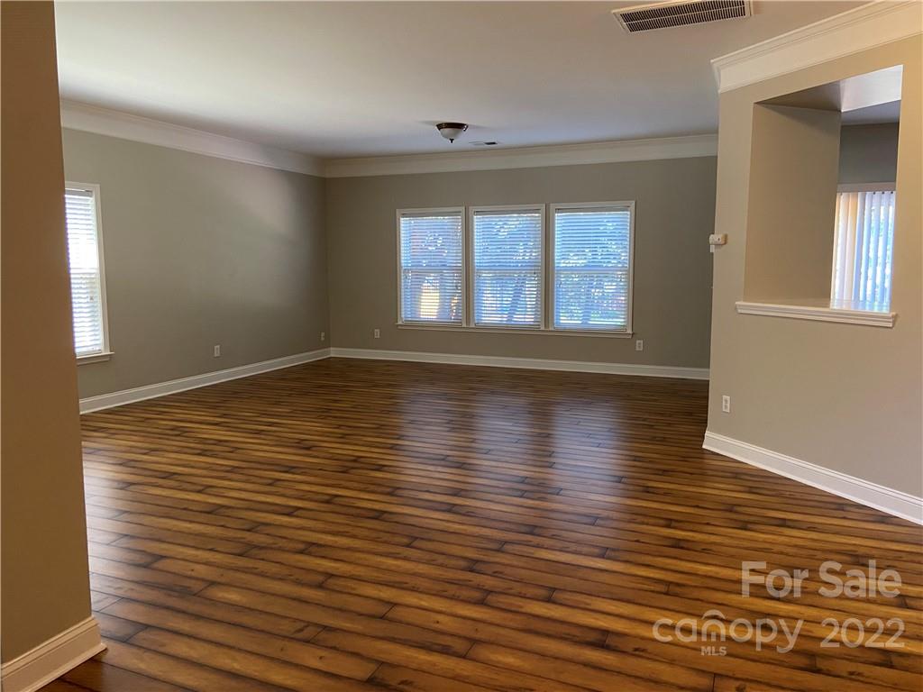 6734 Evanton Loch Road Charlotte, NC 28278 - Photo 11 of 34 a view of empty room with wooden floor and fan