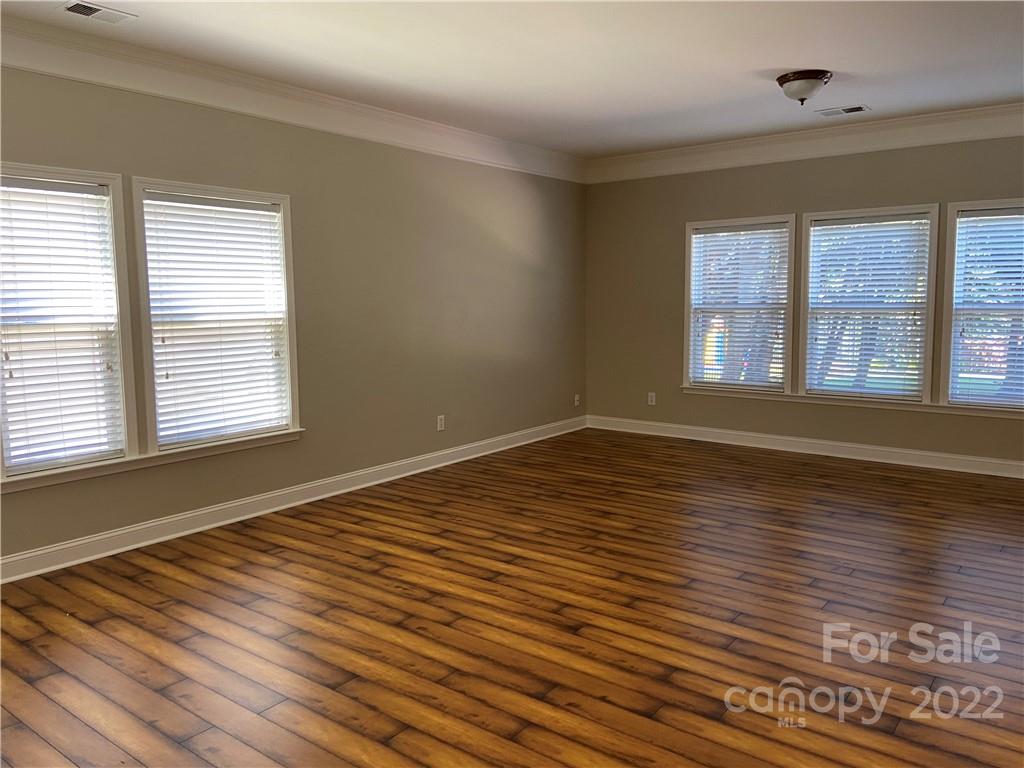 6734 Evanton Loch Road Charlotte, NC 28278 - Photo 12 of 34 a view of empty room with wooden floor and fan