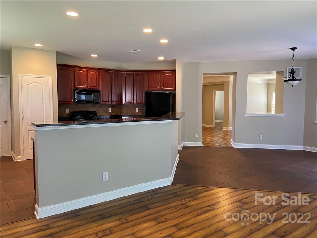 6734 Evanton Loch Road Charlotte, NC 28278 - Photo 13 of 34 a kitchen with stainless steel appliances a refrigerator sink and microwave