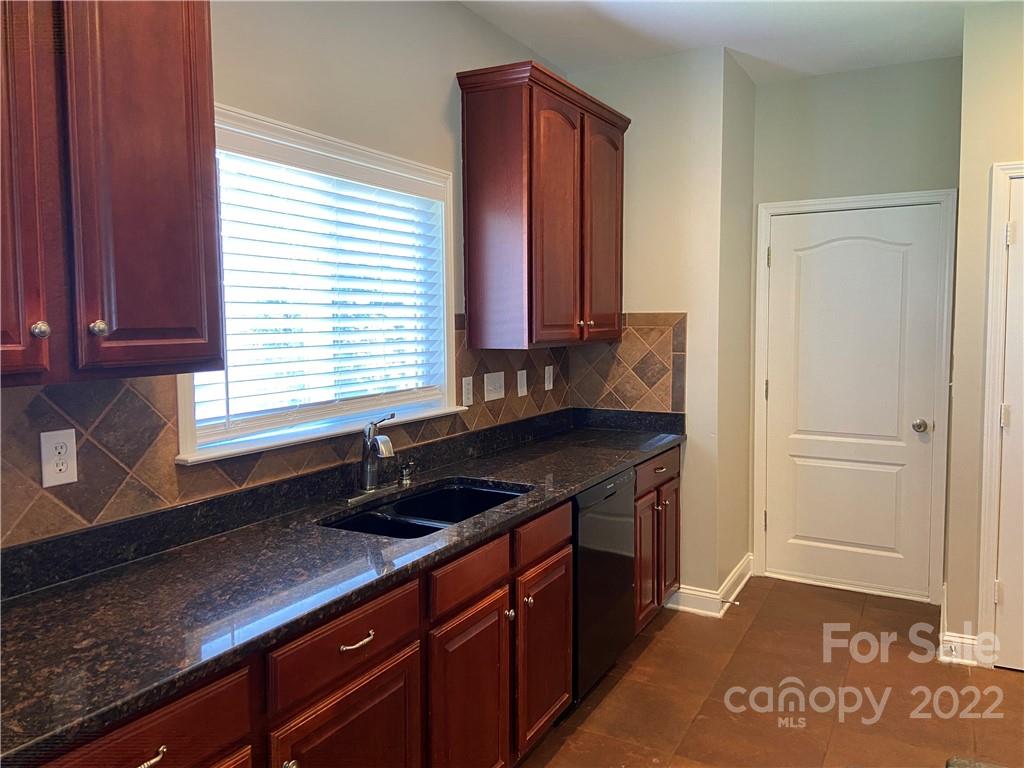 6734 Evanton Loch Road Charlotte, NC 28278 - Photo 15 of 34 a kitchen with granite countertop a sink and a stove