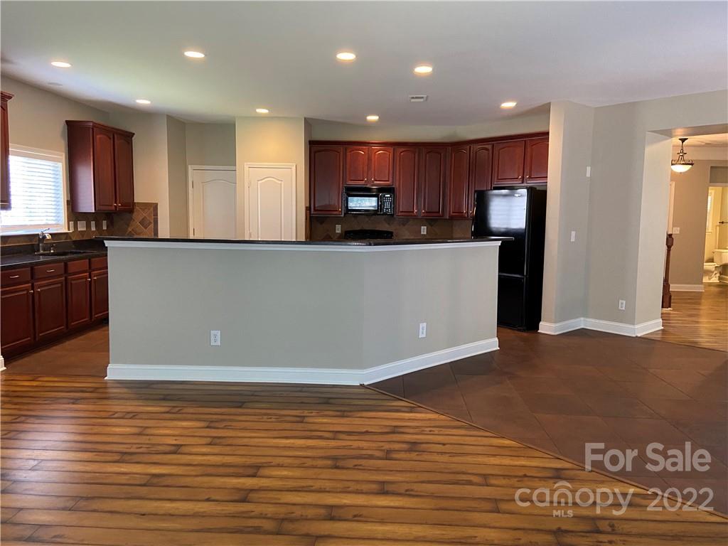 6734 Evanton Loch Road Charlotte, NC 28278 - Photo 17 of 34 a view of kitchen with stainless steel appliances granite countertop a refrigerator a sink and a stove