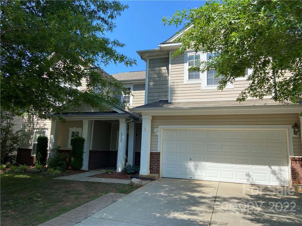 6734 Evanton Loch Road Charlotte, NC 28278 - Photo 2 of 34 a front view of a house with a yard and garage