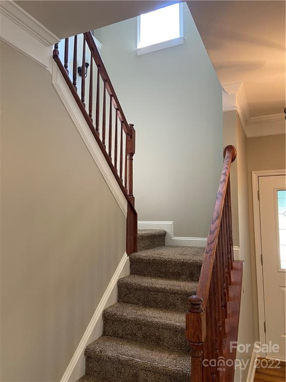 6734 Evanton Loch Road Charlotte, NC 28278 - Photo 22 of 34 a view of staircase with wooden floor and white walls