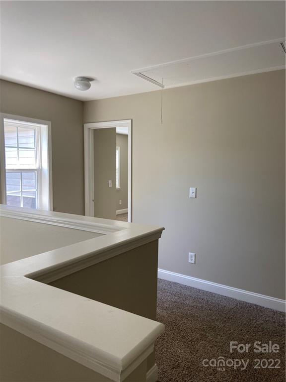 6734 Evanton Loch Road Charlotte, NC 28278 - Photo 23 of 34 a view of an empty room with wooden floor and a window