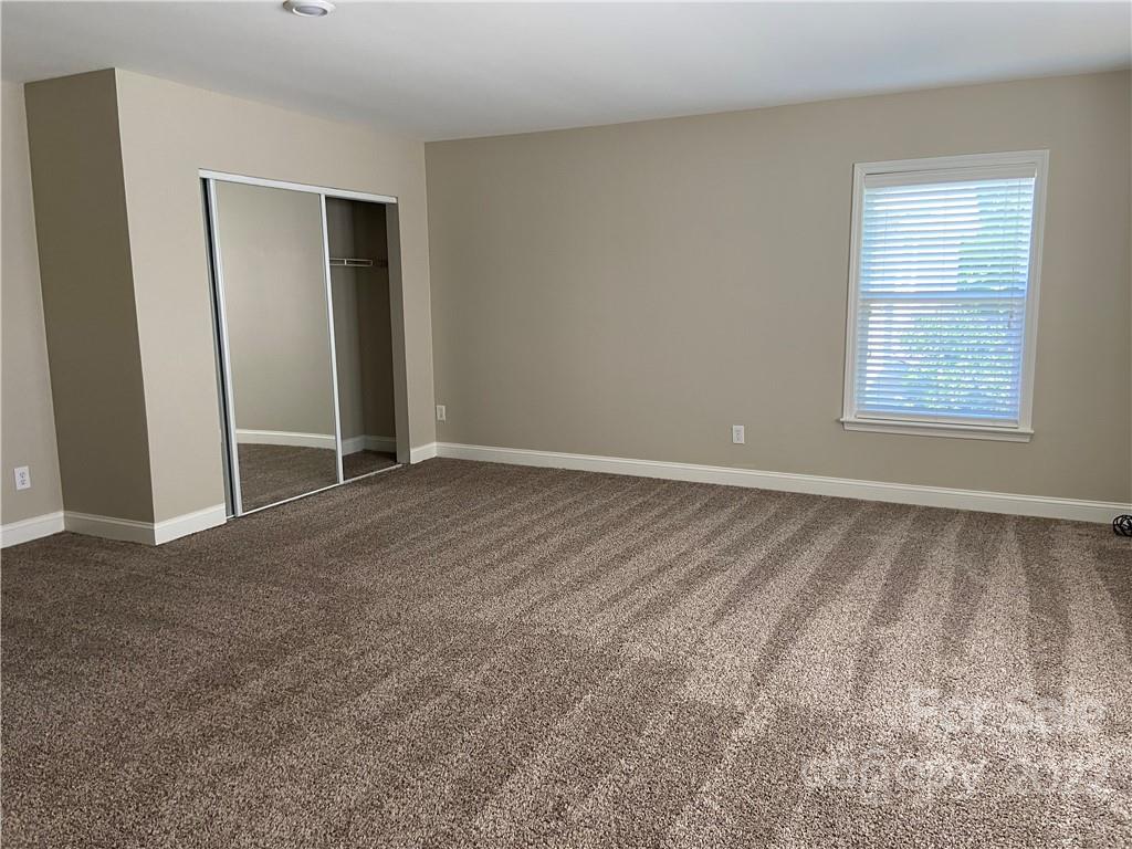 6734 Evanton Loch Road Charlotte, NC 28278 - Photo 25 of 34 an empty room with windows and closet