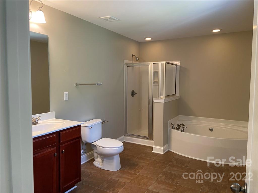 6734 Evanton Loch Road Charlotte, NC 28278 - Photo 28 of 34 a bathroom with a sink a toilet and shower