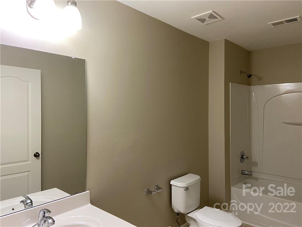 6734 Evanton Loch Road Charlotte, NC 28278 - Photo 30 of 34 a white toilet sitting next to a bathroom sink