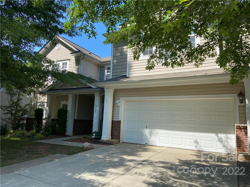 6734 Evanton Loch Road Charlotte, NC 28278 - Photo 3 of 34 a front view of a house with a yard and garage