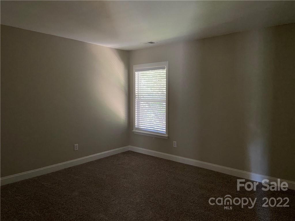 6734 Evanton Loch Road Charlotte, NC 28278 - Photo 32 of 34 an empty room with a window