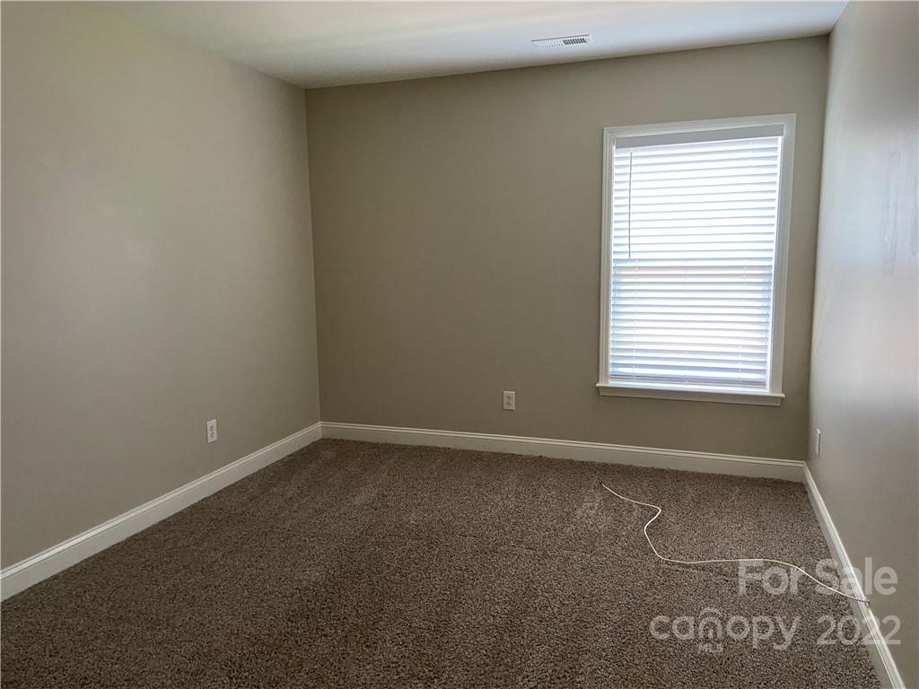 6734 Evanton Loch Road Charlotte, NC 28278 - Photo 33 of 34 an empty room with a window