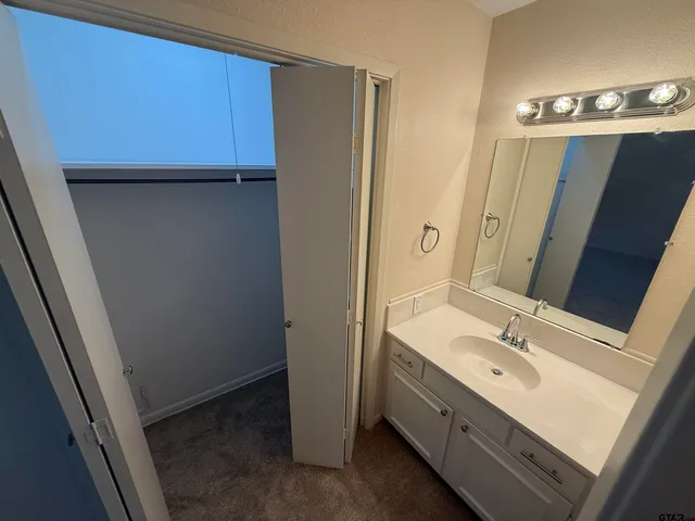 a bathroom with a double vanity sink and mirror