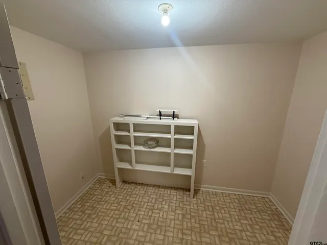 a room with a bench and cabinets