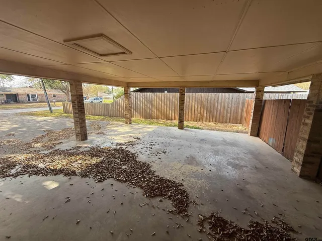 a view of a backyard with wooden fence