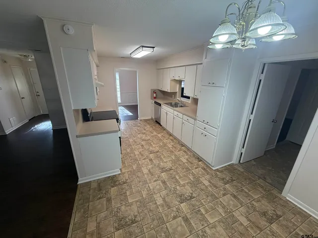 a living room with stainless steel appliances furniture and a fireplace