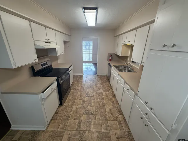 a kitchen with sink a stove and refrigerator