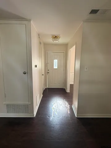 a view of a hallway with wooden floor